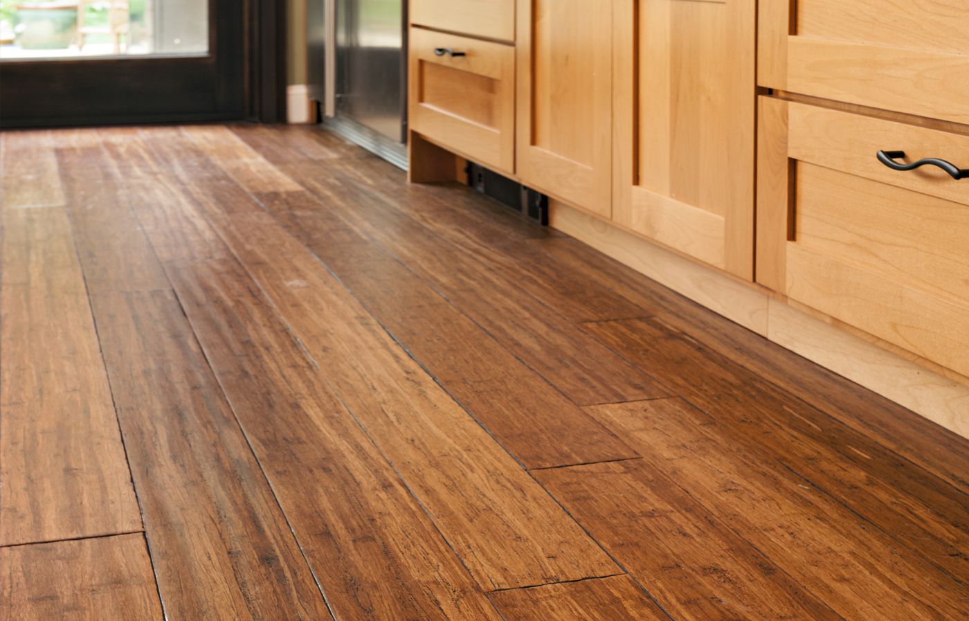 Bamboo flooring stained a deep brown in a kitchen.