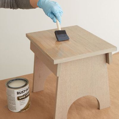 applying a varnish over the wood stain to give a sun-bleached tone