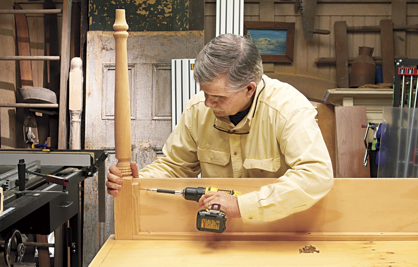 a man installing the cleat onto a desk with a storage cubby.