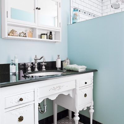 A vintage desk turned into a bathroom vanity.