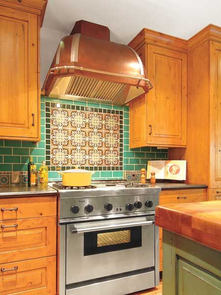 A vent hood in a kitchen over a stove.