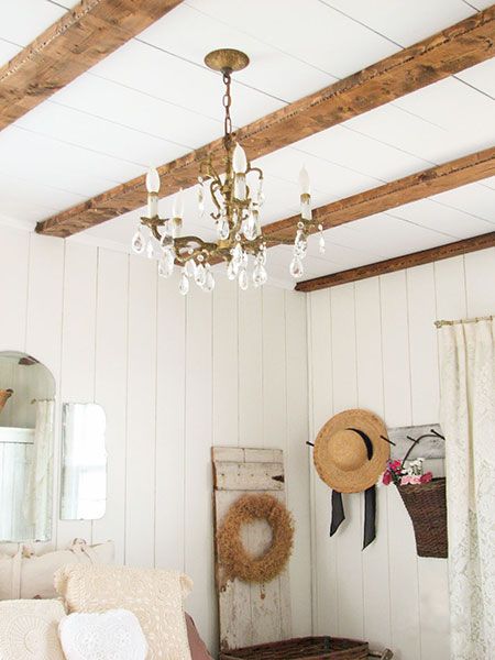 Faux wood beams in a farmhouse-style bedroom.