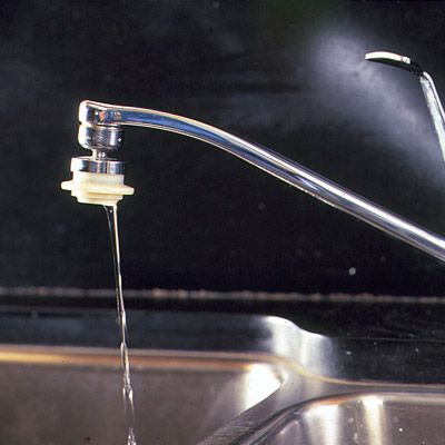 A faucet with sputtering water flow, which can be a common kitchen plumbing problem.