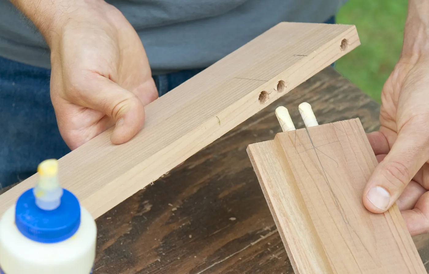 A person using glue to assemble the rame.