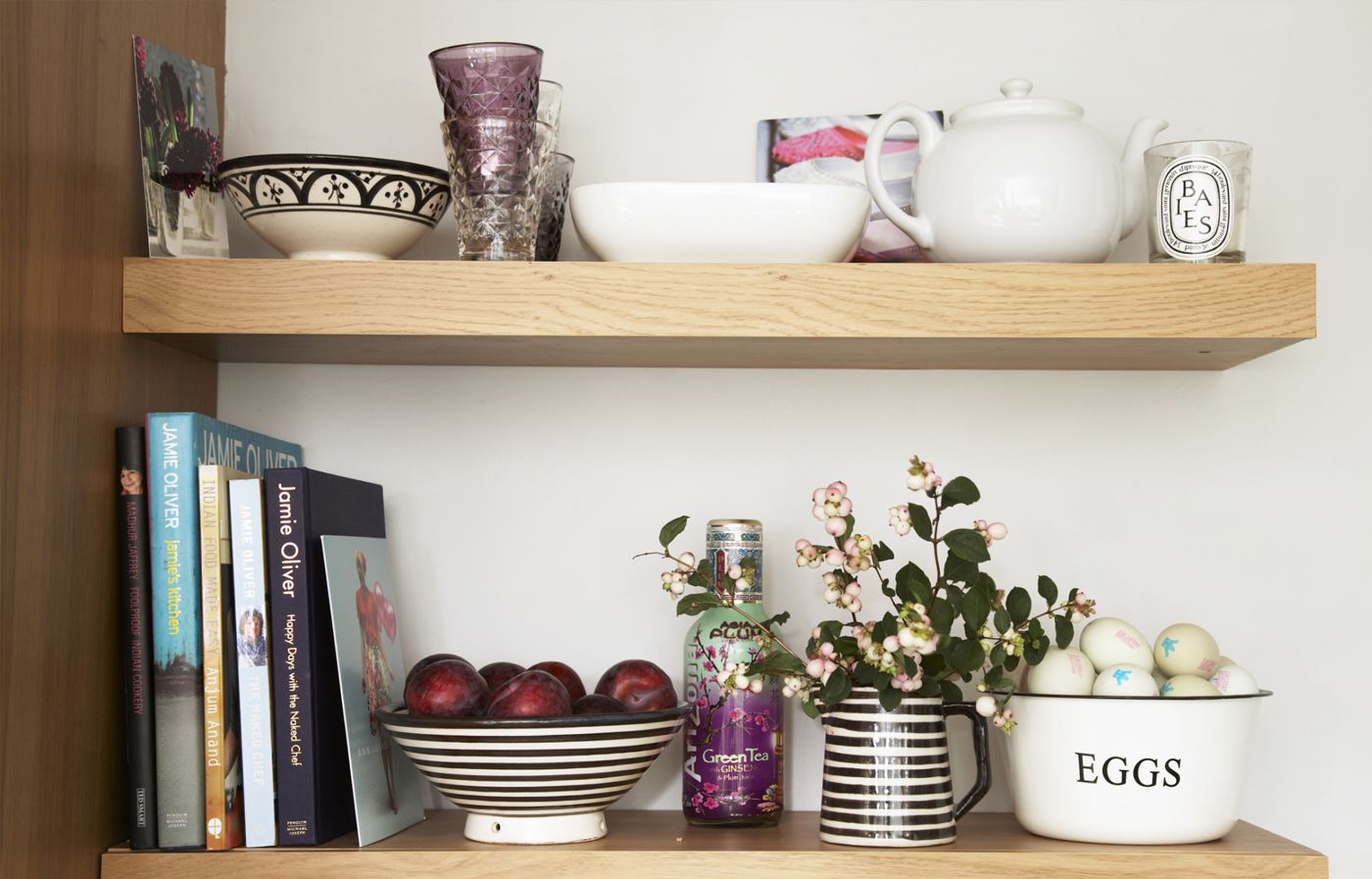 Open kitchen shelves with a variety of functional and decorative items.