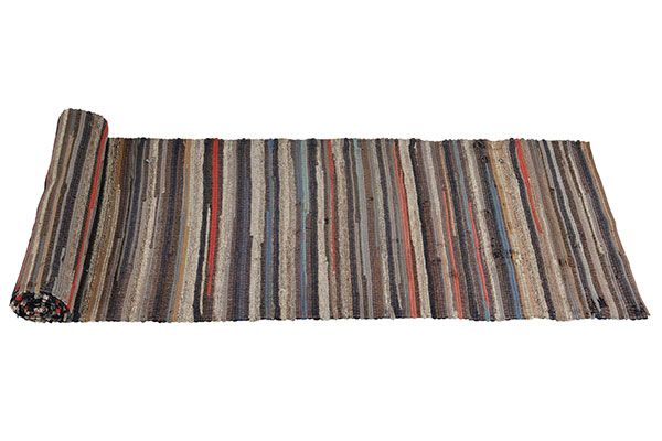 A half unrolled rag hallway runner rug.