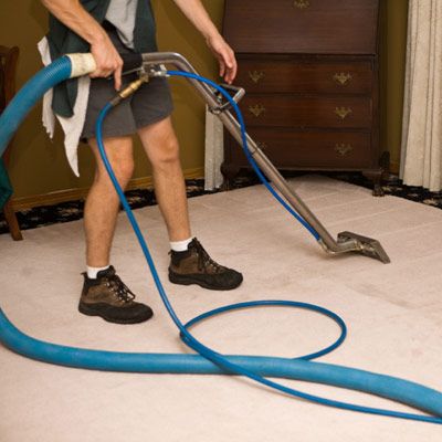 A man using a steam cleaner.