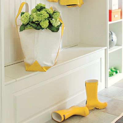 a bag and shoes on a bench seat within a mudroom