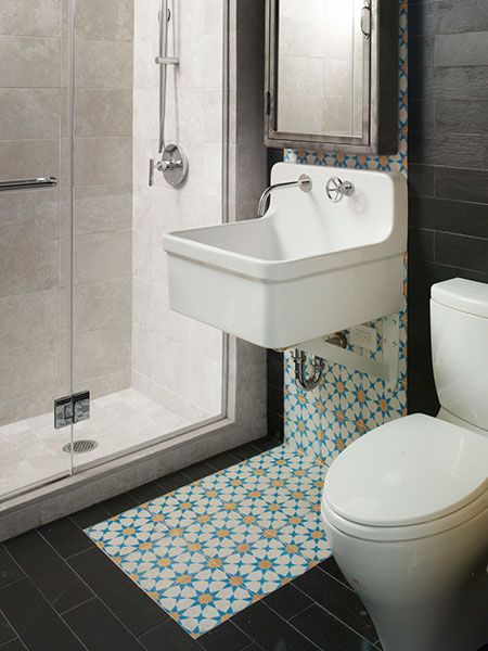 Blue and yellow rug design below the sink which makes its way up the wall as a backsplash