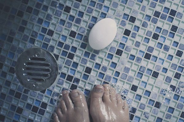 Image of a shower floor tiled with many small tiles