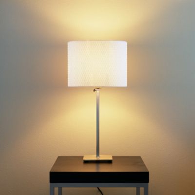 A desk lamp that is turned on.