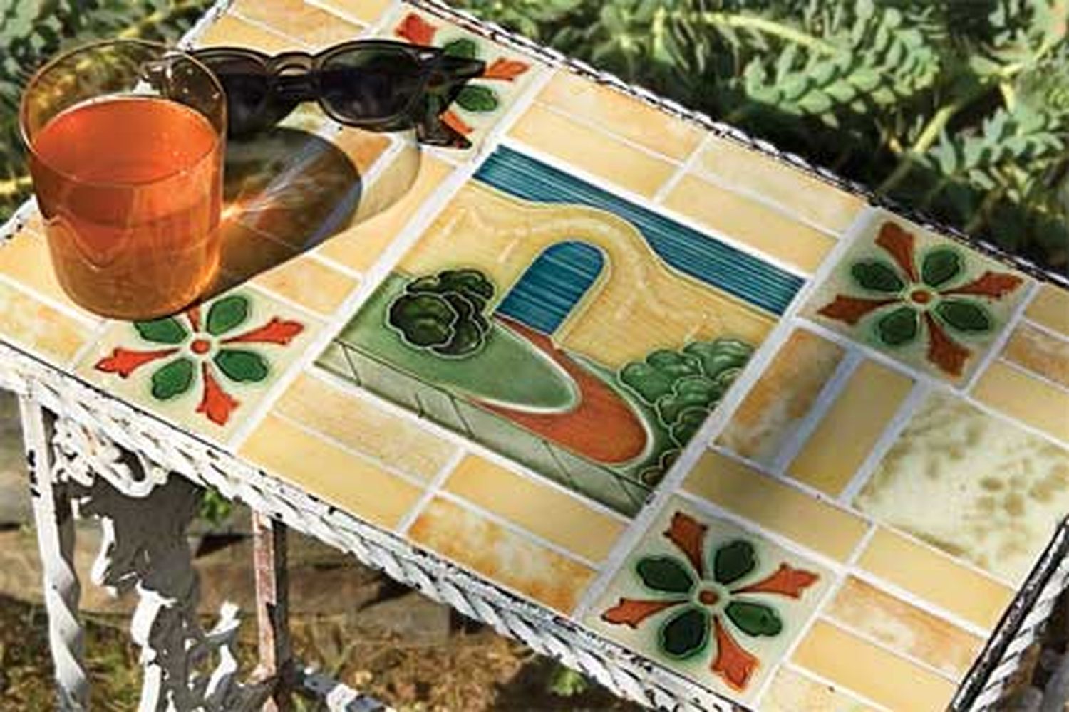 A vintage tile tabletop with a glass on it