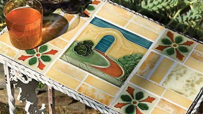 A vintage tile tabletop with a glass on it