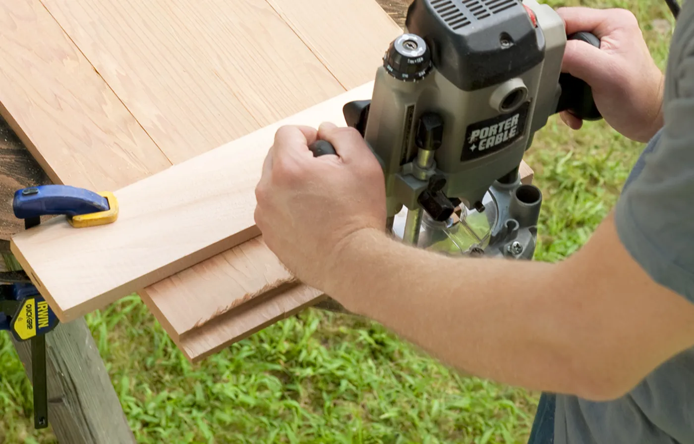 A person using a power tool to rout the slats.
