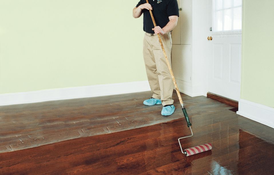 A man rolls across the hardwood floors.