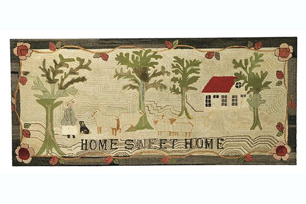 A hooked rug that says "Home Sweet Home" and includes images of a house, trees, sheep, and a woman with her dog.