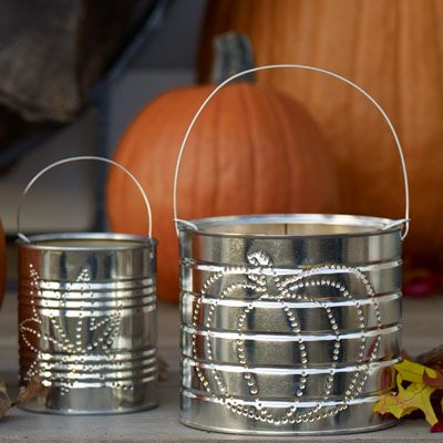 adding a light to the middle of the tin can to make a lantern