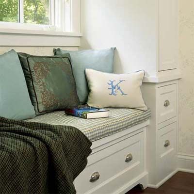 A reading nook combined with storage cabinets