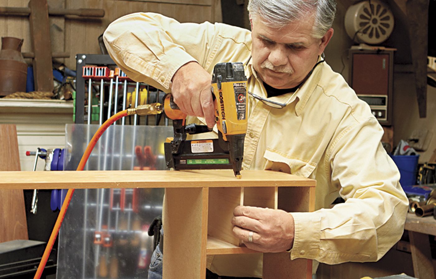 A man building a hutch for a desk.