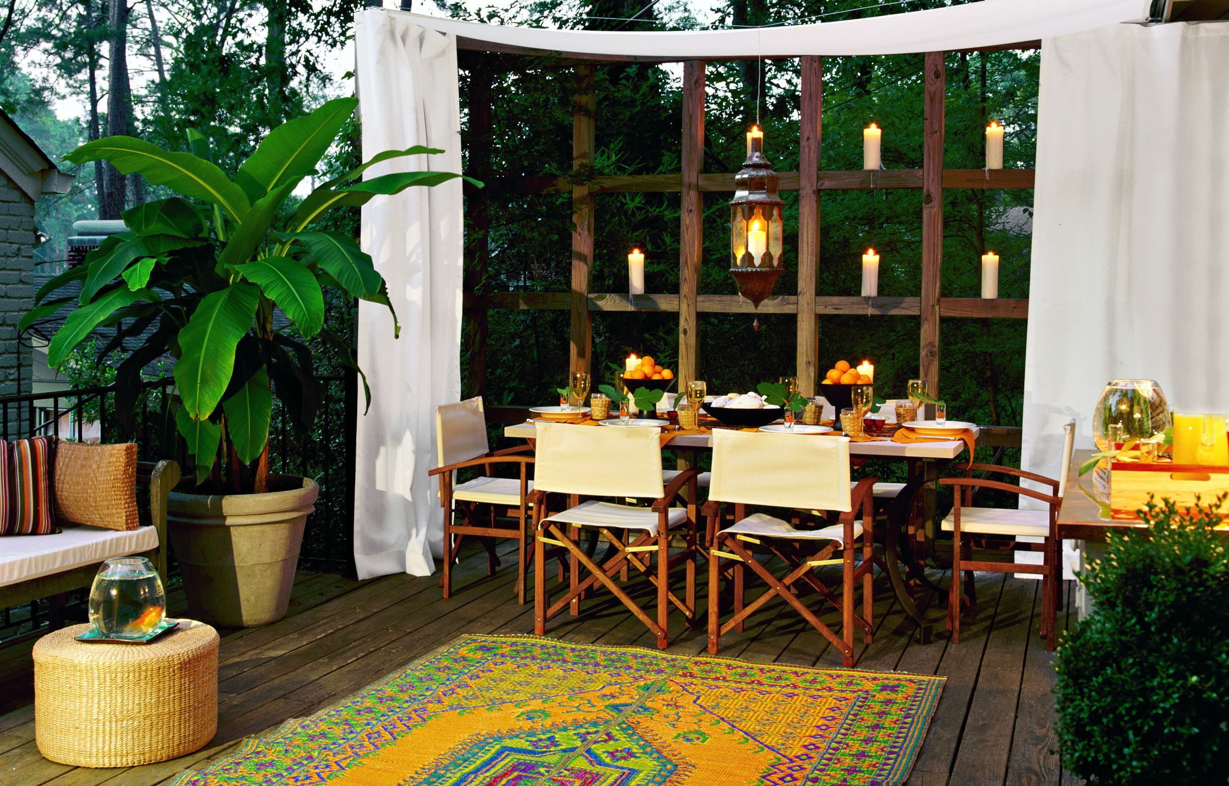 A curtained alcove outdoor dining space.