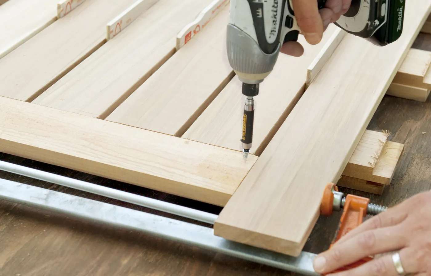 Someone carefully attaching the slats and concealing the fasteners.