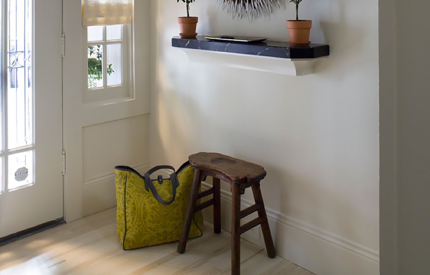 a stool for sitting near a front door