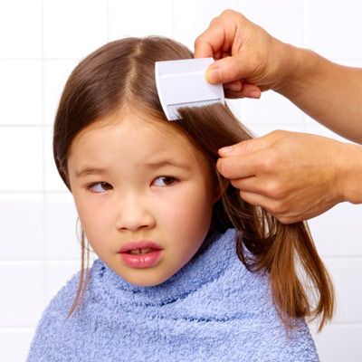 A child whose hair is being brushed.