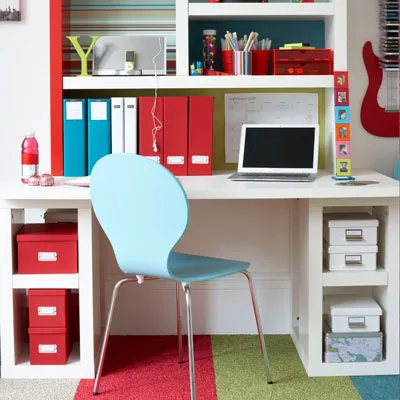 A study area with bright pops of color from red storage boxes. 