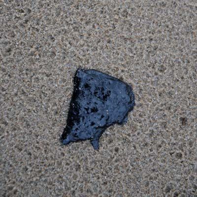 Tar sitting on a surface.