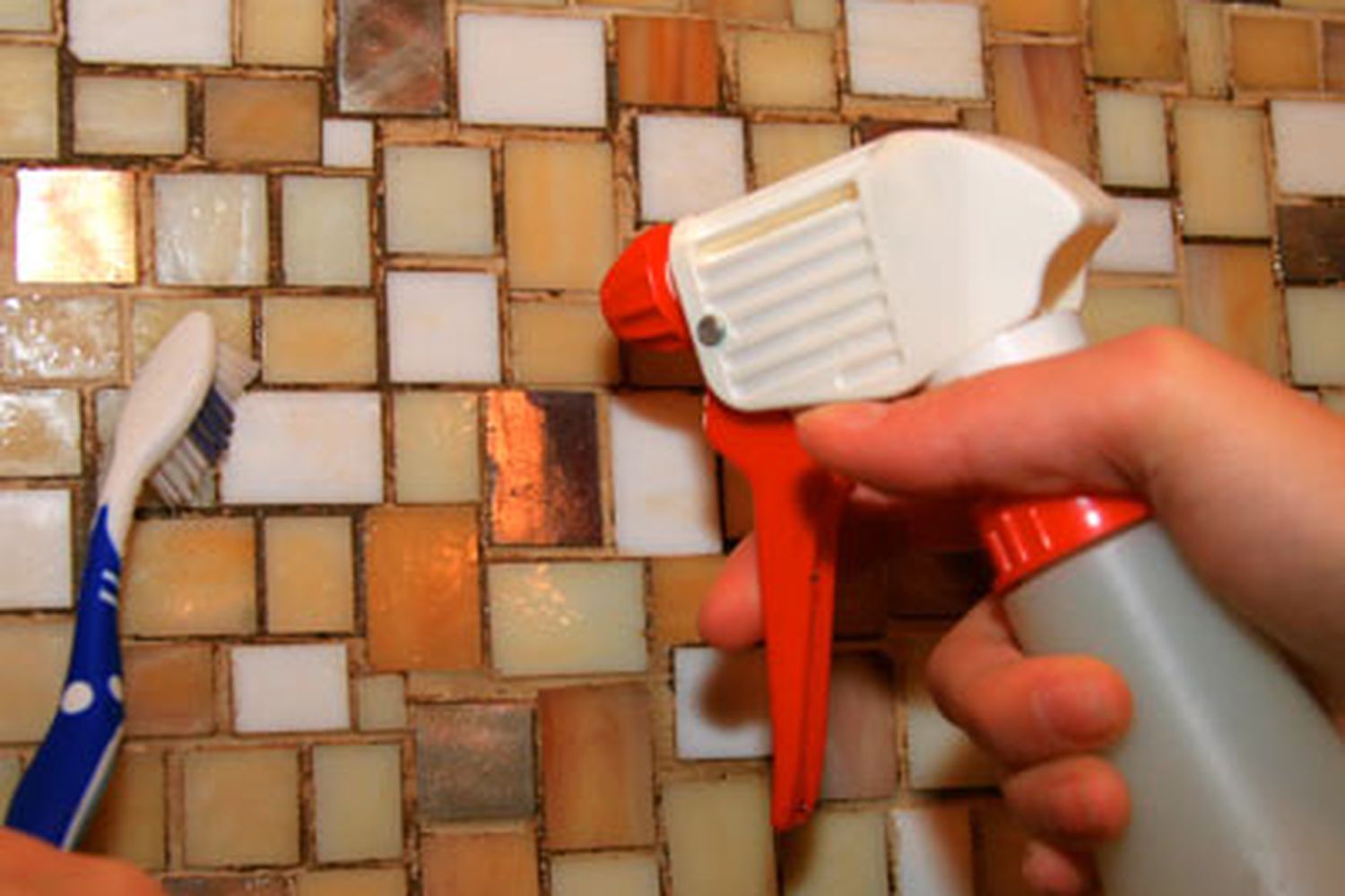 Vodka being sprayed against the wall, to be cleaned with a toothbrush.