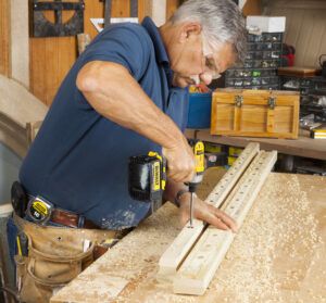 Two images of a man constructing a spindle headboard.