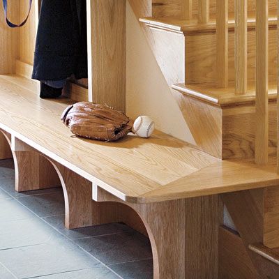 an up close look of a bench in a mudroom along a stairwell