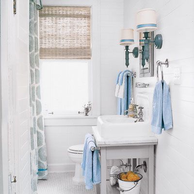 A bathroom with a white and blue color scheme. 