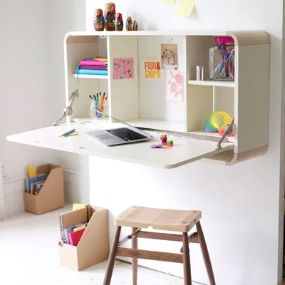 A wall mounted folding desk which opens up and can be used as a storage solution. 