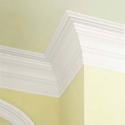 A yellow painted wall with crown molding.