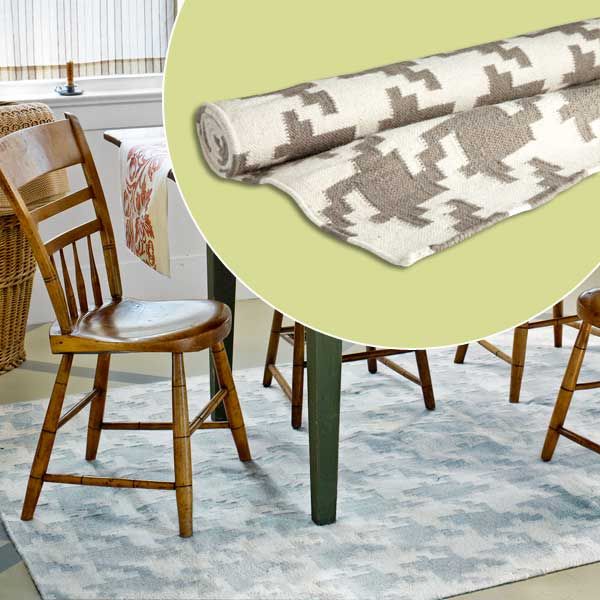 A houndstooth rug sitting under a dining room table and chairs.