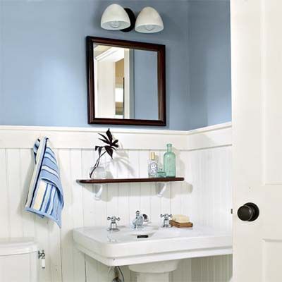 A bathroom painted blue with crown molding.