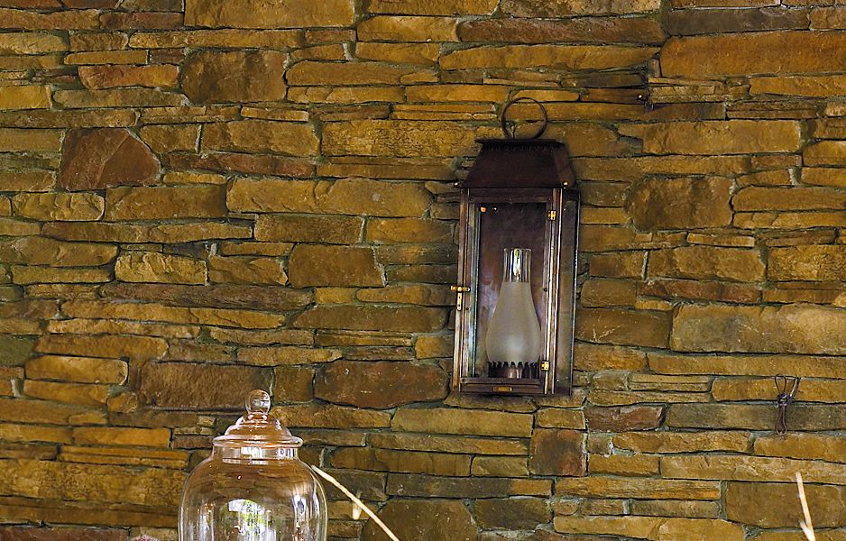 A hanging lantern in an outdoor dining space.