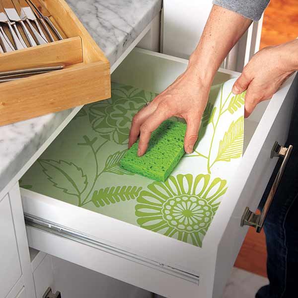 A drawer lined with wallpaper scraps