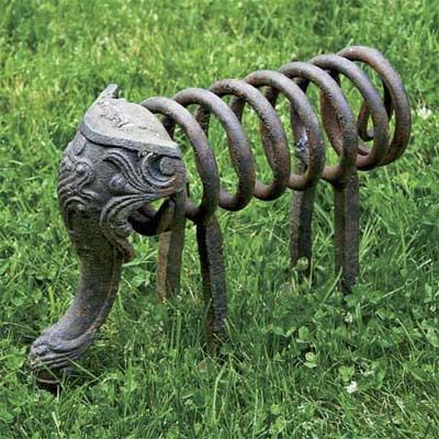 a metal elephant sculpture in the garden