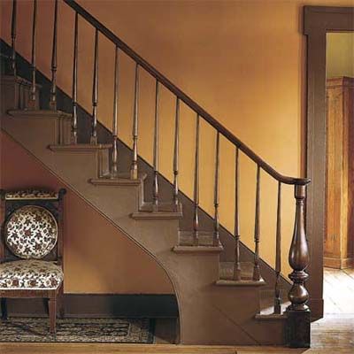 A stairwell set against an orange painted wall.