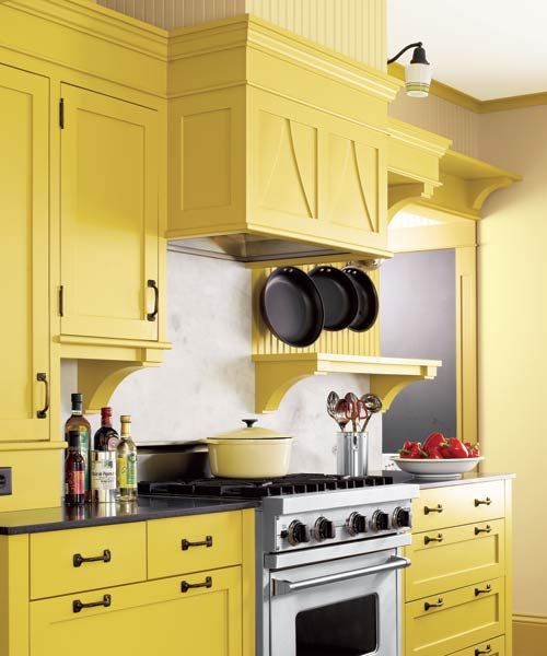 A vent hood insert over a stove in a kitchen.