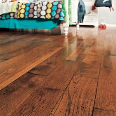 Distressed hardwood flooring in a bedroom.