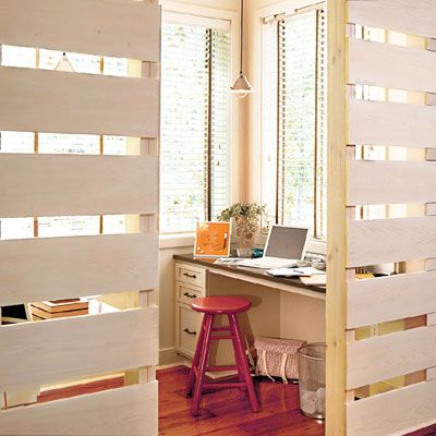 Study area within a larger room sectioned off by room dividers.