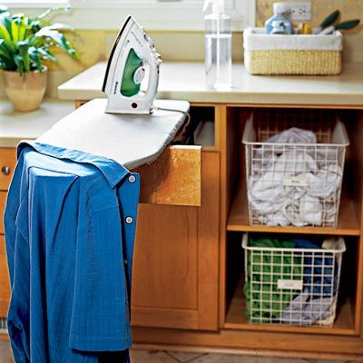 Man putting clothes in the washing machine, in the kitchen, worried because  he has to wash a lot of clothes. Close up Stock Photo - Alamy