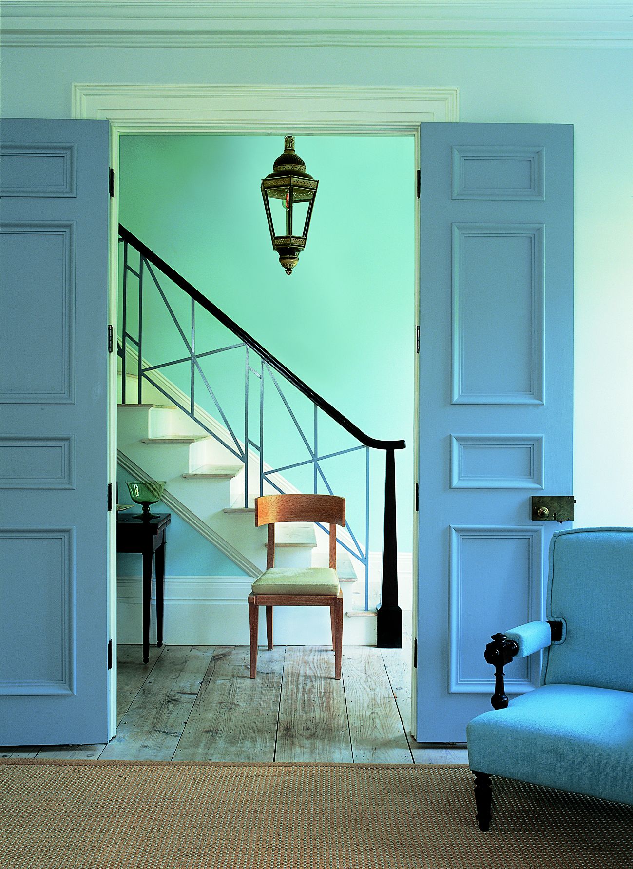 one large pendant light hanging in a foyer