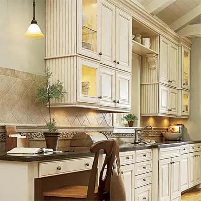 A sit down kitchen desk with adequate lighting and multiple light sources. 