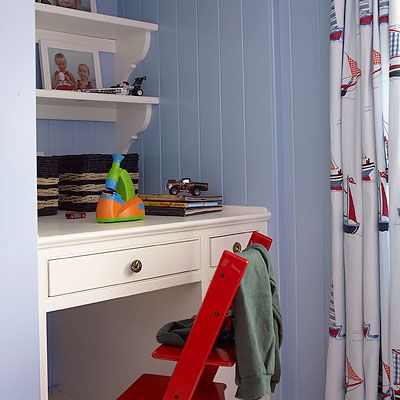 Corner desk with floating shelves in a child's bedroom