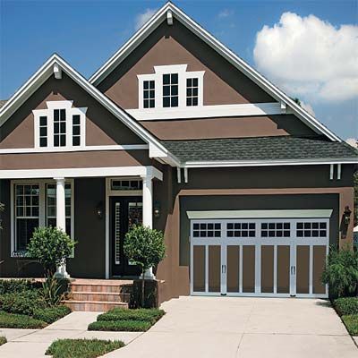 A brown house with a brown craftsman garage door and white trim.