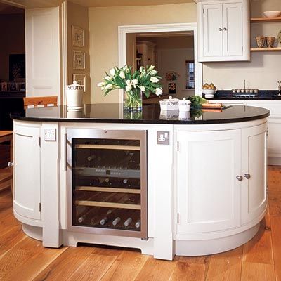 A white, rounded kitchen island.